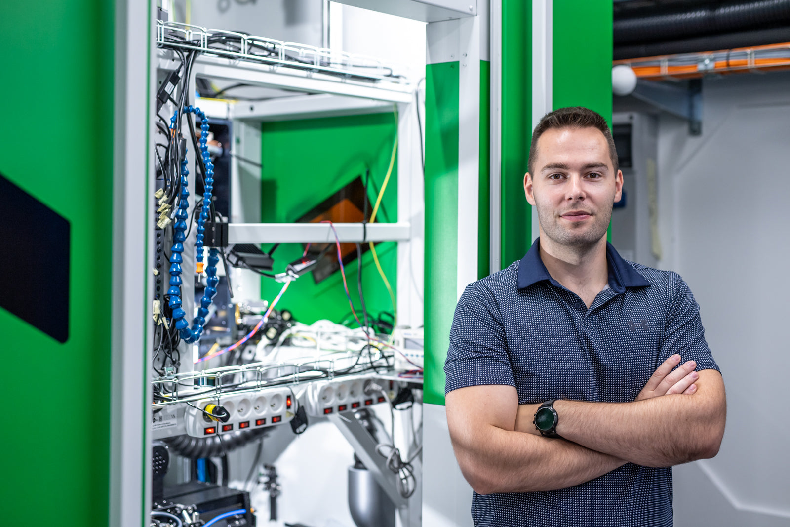 Petr Hauschwitz beside laser micromachining equipment