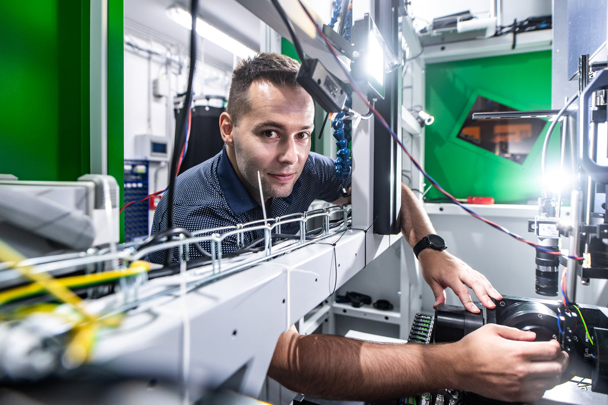 Petr Hauschwitz working with laser laboratory equipment