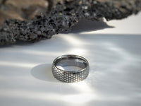 Product photo of the Eclipse Harmony Ring with laser-engraved surface detail.