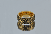 Product photo of the Golden Mokume Majesty tungsten ring with laser-engraved surface detail.