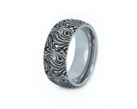 White Gold Mokume Majesty tungsten ring with laser-engraved surface detail, shown against a light background.