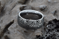 Product photo of the White Gold Mokume Majesty tungsten ring with laser-engraved surface detail.