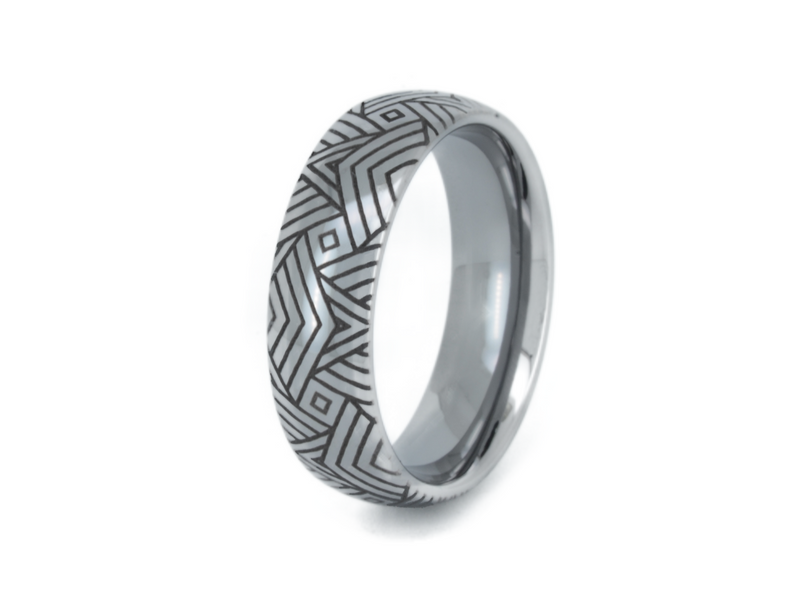 The Arrow Waves tungsten ring with laser-engraved surface detail, shown against a light background.