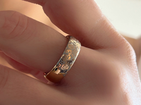 White Blooming Rose tungsten ring with laser-engraved surface detail, worn on a hand.