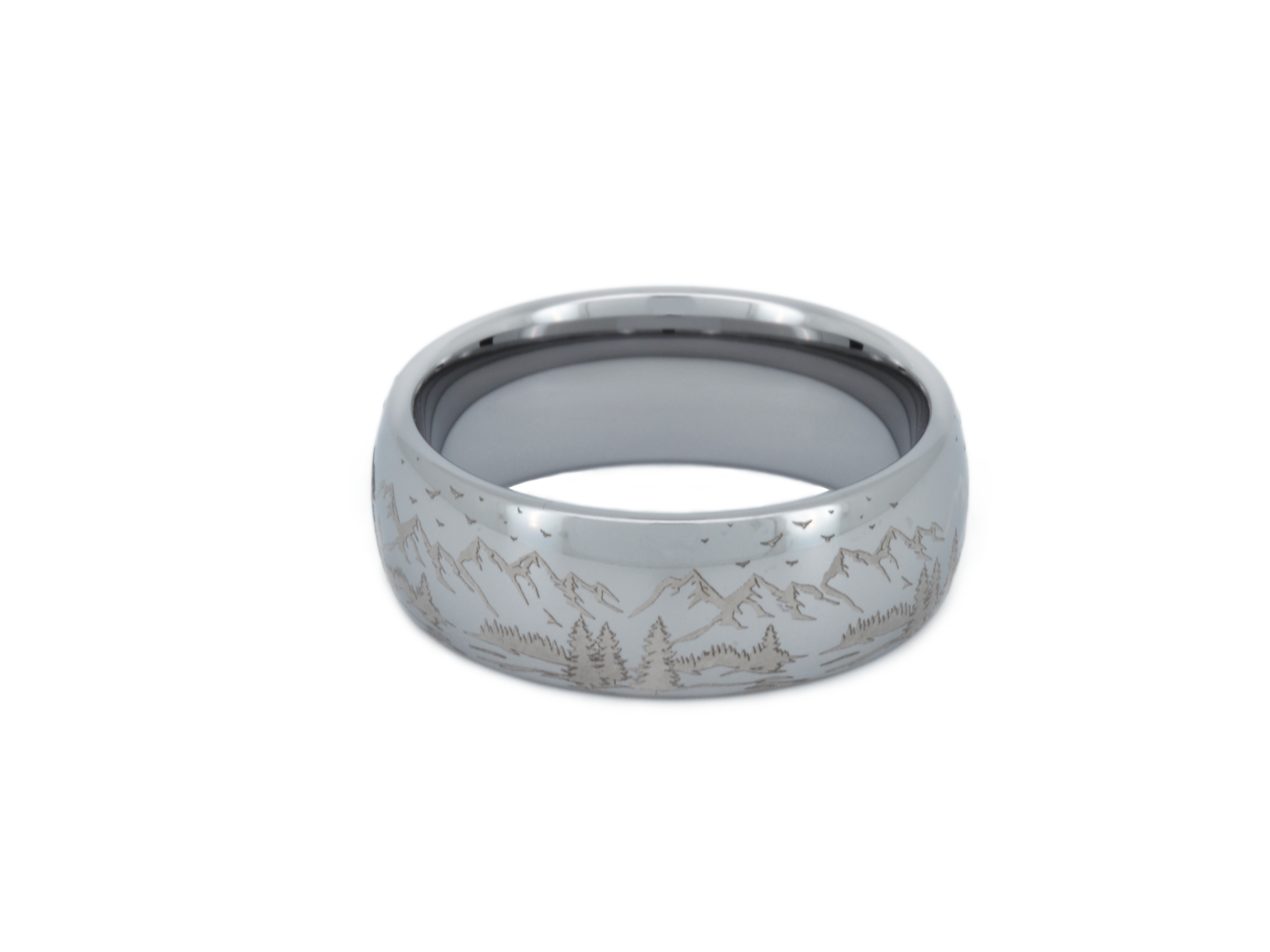 Silver tungsten ring with an engraved mountain range design, isolated on a white background.