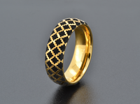 Product photo of the Golden Black Quilted Elegance tungsten ring with laser-engraved surface detail.