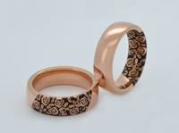 Product photo of the Black Blooming Rose tungsten ring with laser-engraved surface detail.