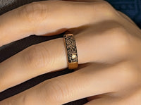 Black Blooming Rose tungsten ring with laser-engraved surface detail, worn on a hand.