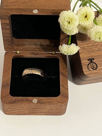 Product photo of the White Blooming Rose tungsten ring with laser-engraved surface detail.