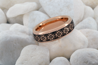 Product photo of the Tribal Pixels tungsten ring with laser-engraved surface detail.