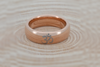 Product photo of the Om Harmonie tungsten ring with laser-engraved surface detail.