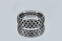 Tungsten ring with a white gold-plated surface and a timeless diamond pattern displayed on a mirror