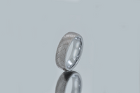 Product photo of the Urban Herringbone tungsten ring with laser-engraved surface detail.