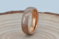 Product photo of the Petal Dance tungsten ring with laser-engraved surface detail.