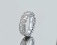 Product photo of the Floral Reverie tungsten ring with laser-engraved surface detail.
