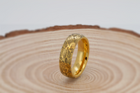 Product photo of the Delicate Oak Leaf tungsten ring with laser-engraved surface detail.