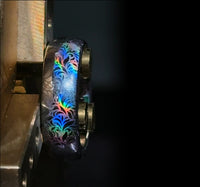 Product photo of the Glowing Reverie tungsten ring with a laser-created holographic surface effect.