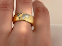 Golden Globe tungsten ring with laser-engraved surface detail, worn on a hand.