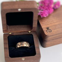 Product photo of the Blooming Grace tungsten ring with laser-engraved surface detail.