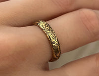 Delicate Oak Leaf tungsten ring with laser-engraved surface detail, worn on a hand.