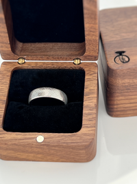 Product photo of the Urban Herringbone tungsten ring with laser-engraved surface detail.