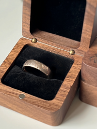 Product photo of the Petal Dance tungsten ring with laser-engraved surface detail.