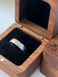 Product photo of the Chain of Unity tungsten ring with laser-engraved surface detail.