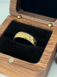 Product photo of the Delicate Oak Leaf tungsten ring with laser-engraved surface detail.