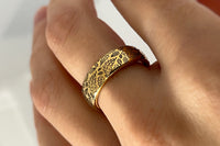 Delicate Oak Leaf tungsten ring with laser-engraved surface detail, worn on a hand.