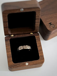 Product photo of the Tribal Pixels tungsten ring with laser-engraved surface detail.