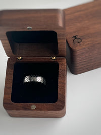 Product photo of the White Gold Quilted Elegance tungsten ring with laser-engraved surface detail.