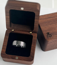 Product photo of the Eclipse Harmony Ring with laser-engraved surface detail.