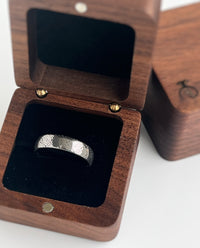 Product photo of the Eternal Knot tungsten ring with laser-engraved surface detail.