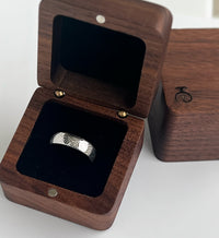 Product photo of the The Arrow Waves tungsten ring with laser-engraved surface detail.