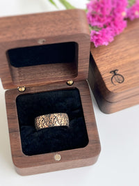 Product photo of the Fluidic Essence tungsten ring with laser-engraved surface detail.