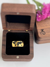 Product photo of the Golden Globe tungsten ring with laser-engraved surface detail.