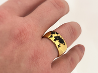 Golden Globe tungsten ring with laser-engraved surface detail, worn on a hand.