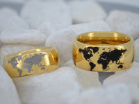 Product photo of the Golden Globe tungsten ring with laser-engraved surface detail.