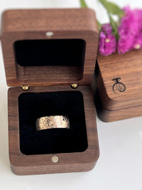 Product photo of the Fluidic Essence tungsten ring with laser-engraved surface detail.
