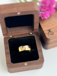 Product photo of the Golden Globe tungsten ring with laser-engraved surface detail.