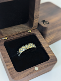 Product photo of the Golden Mosaic tungsten ring with laser-engraved surface detail.