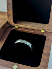 Product photo of the Silver Blooming Rose tungsten ring with laser-engraved surface detail.