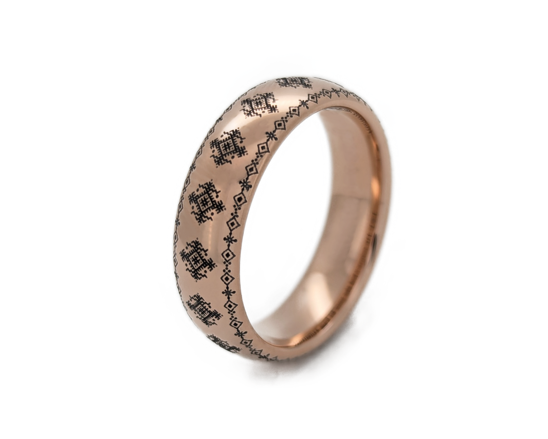 Rose gold ring with engraved design on a light gray background