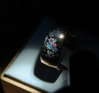 Blooming Light tungsten ring with a laser-created holographic surface effect, shown against a light background.