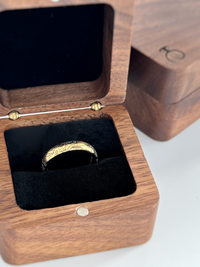 Product photo of the Delicate Oak Leaf tungsten ring with laser-engraved surface detail.
