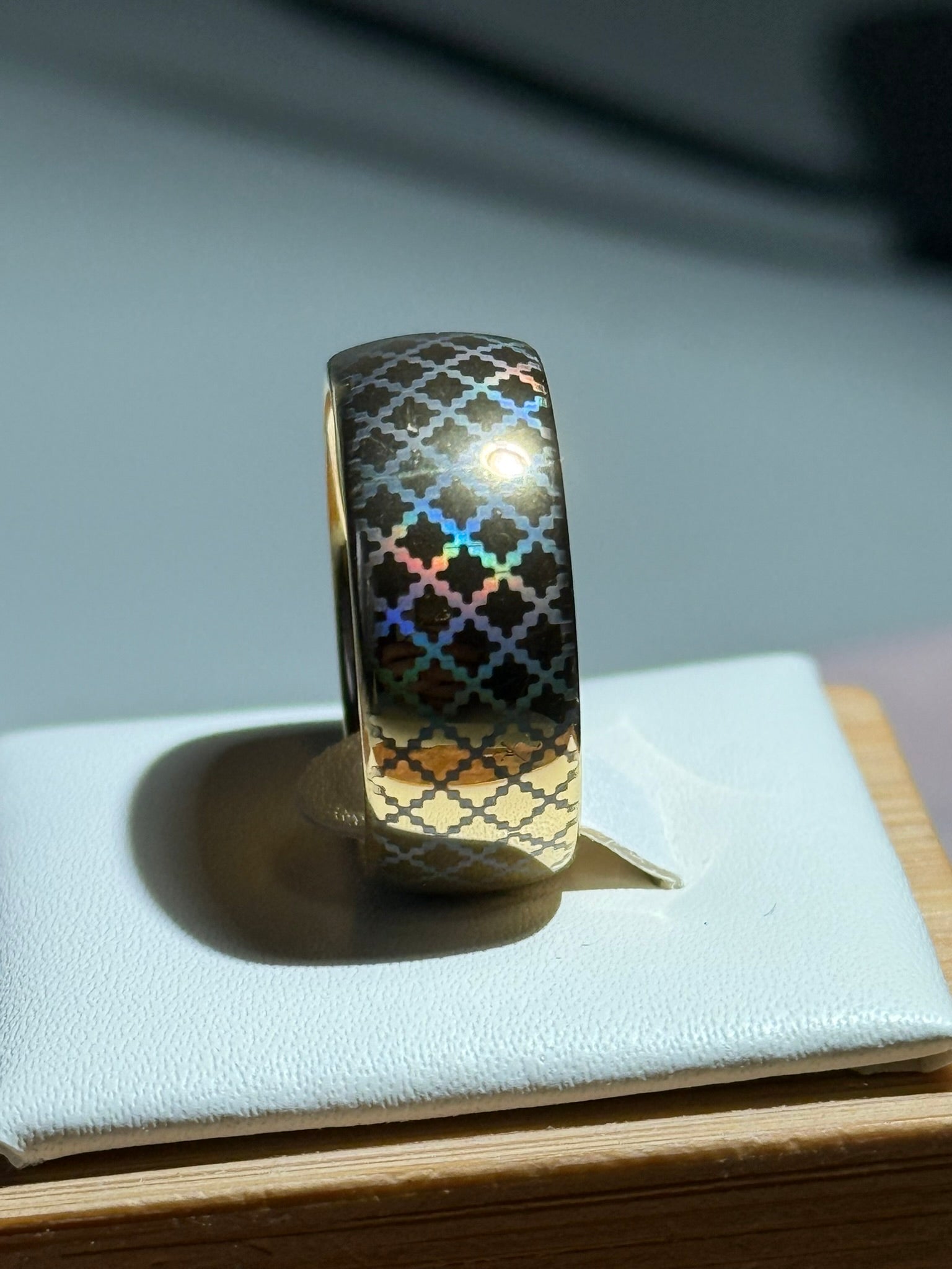 Quilted Grace tungsten ring with a laser-created holographic surface effect, shown against a light background.