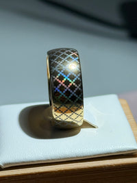 Quilted Grace tungsten ring with a laser-created holographic surface effect, shown against a light background.