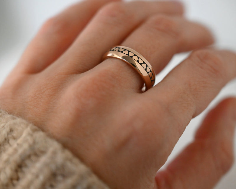 Eternal Heart Band with laser-engraved surface detail, worn on a hand.