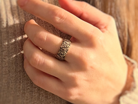 Fluidic Essence tungsten ring with laser-engraved surface detail, worn on a hand.
