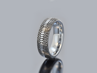 Product photo of the Serpente Eterno Black tungsten ring with laser-engraved surface detail.